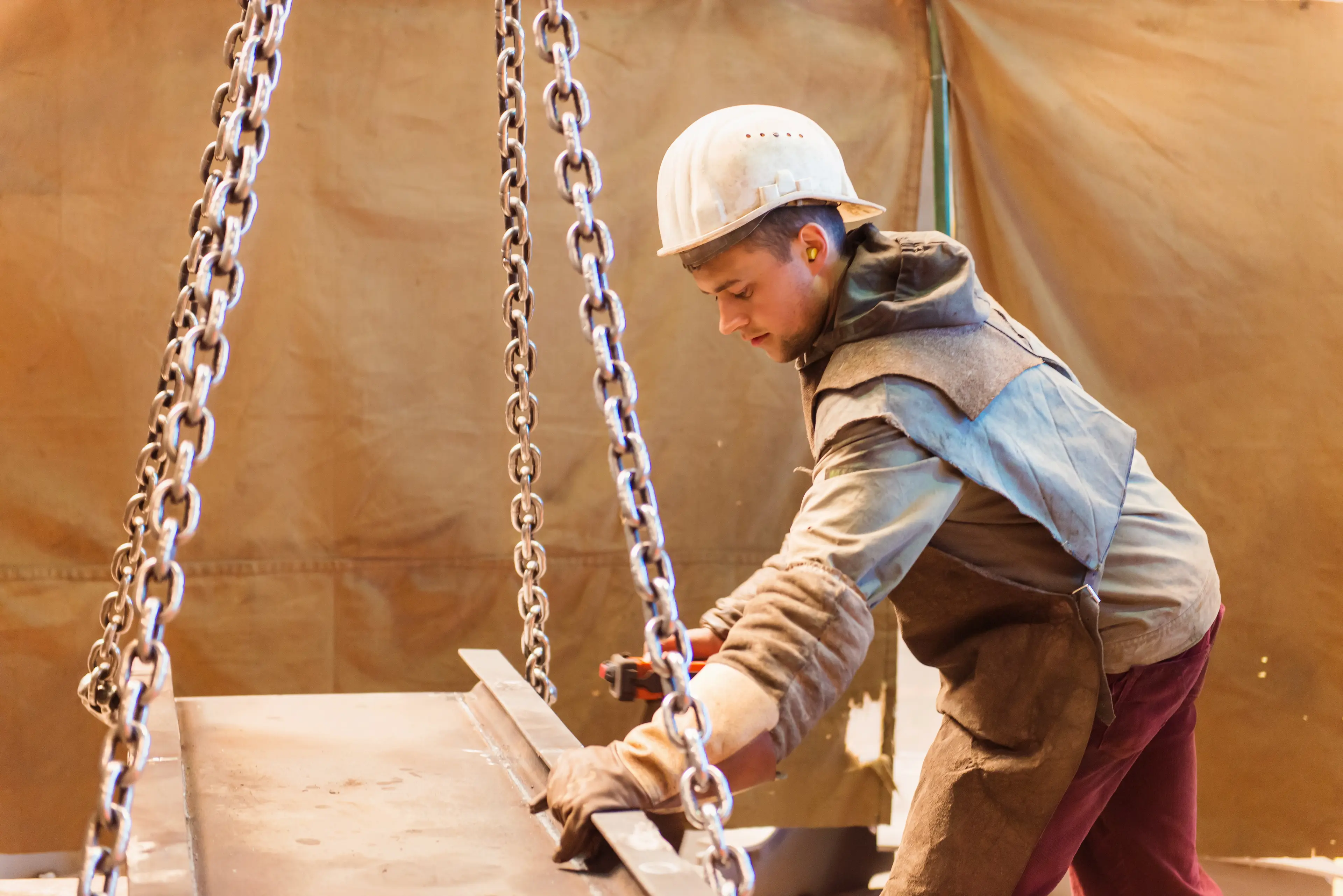 Construction worker using lifting tools to work